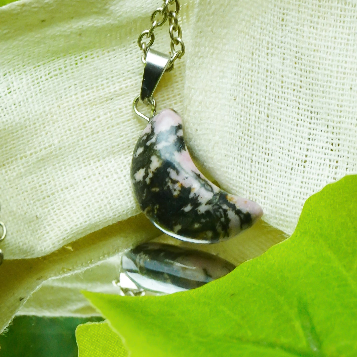 MantraMani® Rhodonite Crystal Half Moon Pendant